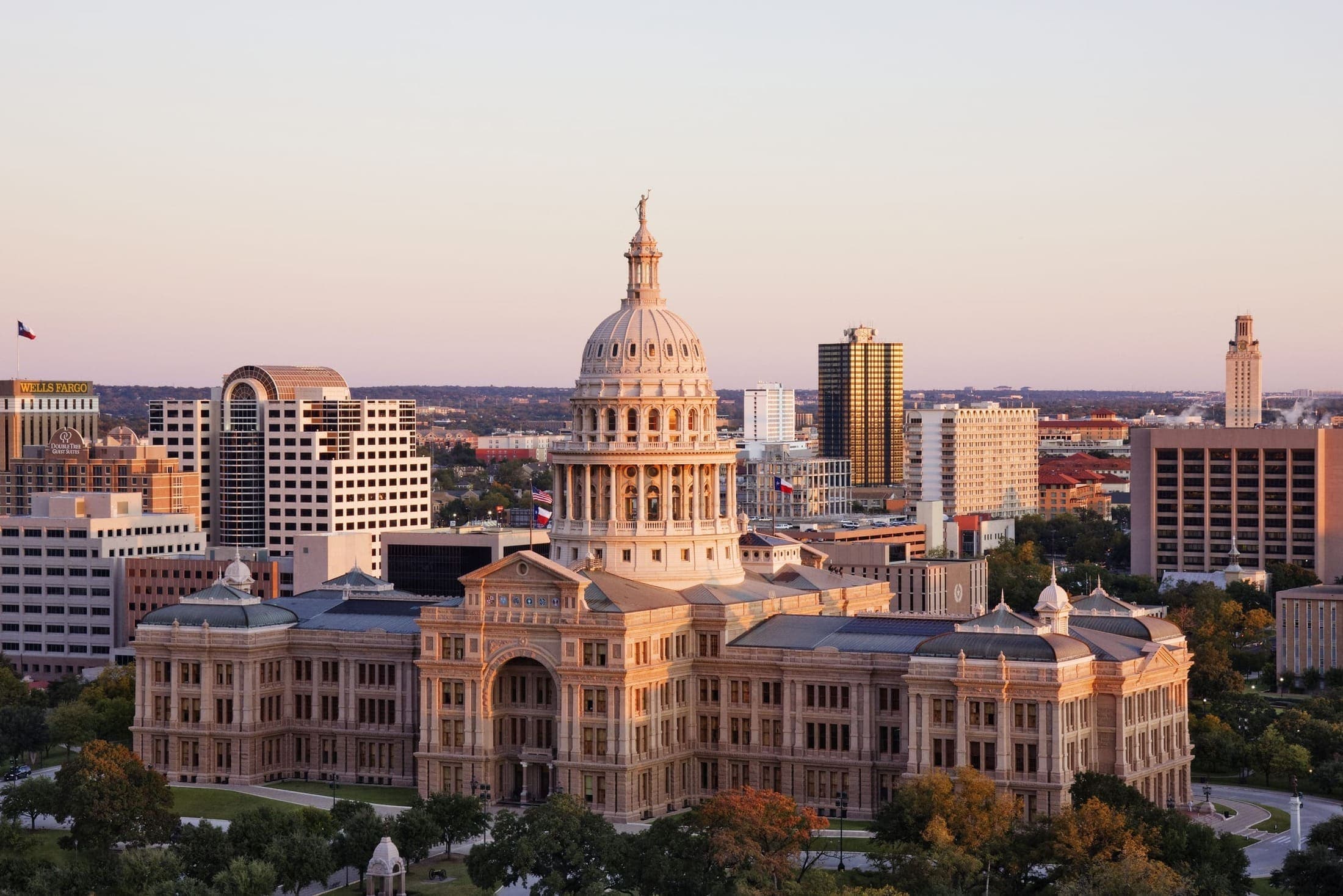 The Texas State Capitol and Austin skyline at dusk